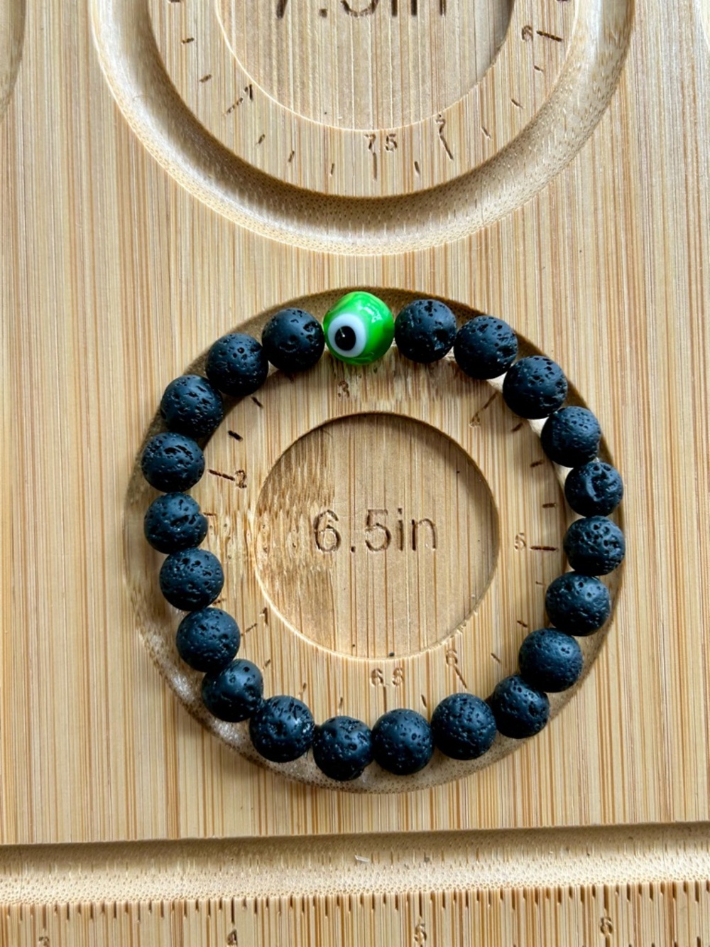 Black Lava Bead Bracelet with Green Eye Accent